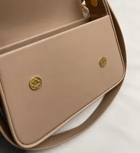 Detail of beige shoulder bag showing invisible magnetic buckles with geometric texture