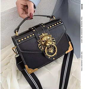 Retro black leather crossbody bag with gold lion buckle and striped strap, main view