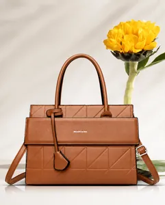 Detailed close-up of brown quilted handbag with shoulder strap and Balado logo