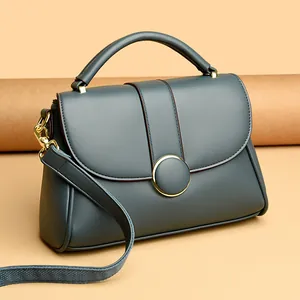 Gray-blue leather handbag with round gold buckle and wide strap for women