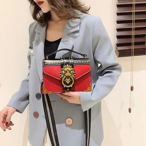 Retro square handbag with red and black contrast, gold lion head and rivet accents