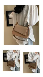 Detailed close-up of mixed texture woven flap and golden logo on crossbody bag