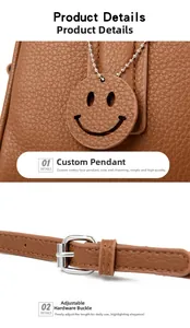 Detail view of brown pebbled leather texture with smiley charm and silver buckle