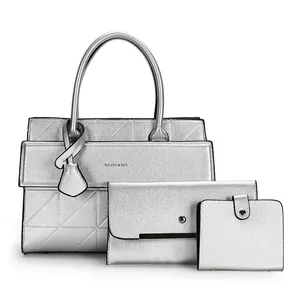Three-piece silver tote bag set with envelope clutch and matching bifold wallet