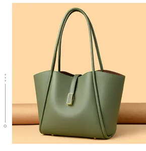 Close-up of fruit green lychee grain leather tote bag with gold buckle and slim handles