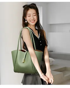 Detailed view of green lychee leather tote bag with elegant gold metal buckle hardware