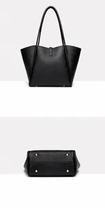 Detail view showing black leather tote bag back and bottom with gold protective metal studs