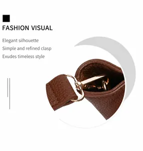 Detail of brown litchi pattern leather tote bag with gold metal hardware lock