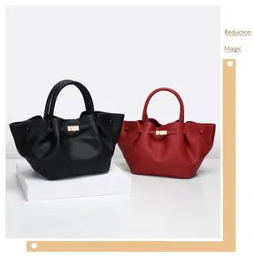 Close-up of litchi grain leather tote bag with elegant gold buckle and round handle