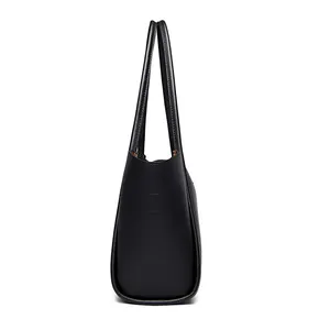 Minimalist black lychee leather bucket tote bag with large capacity and shoulder straps