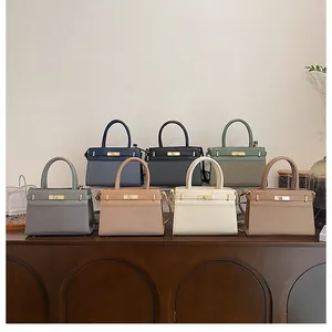 Detailed row of trapezoid handbags in seven colors with textured leather and metal buckles