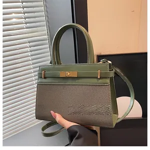 Detail of green PU leather and woven fabric handbag with a golden metal twist lock closure