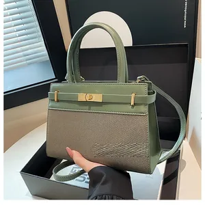 Detail of green handbag showing twill weave texture and elegant metallic turn-lock buckle