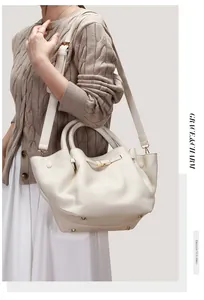 Close-up of white lychee leather tote bag with gold hardware and removable strap