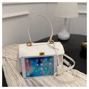 White minimalist shoulder bag shown with a tablet to demonstrate its large daily capacity