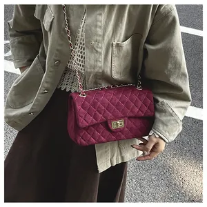 Street view of quilted velvet crossbody bag with gold chain strap in wine red color