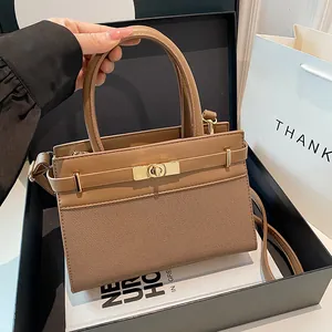 Fashionable brown contrast textured crossbody handbag with gold twist lock and long strap