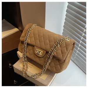Detailed view of brown quilted velvet bag with gold twist lock and chain strap