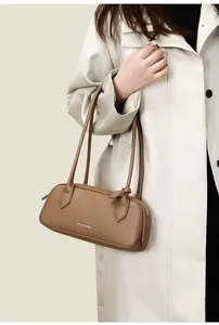 Dettaglio della borsa baguette in pelle marrone a grana litchi con doppie tracolle
