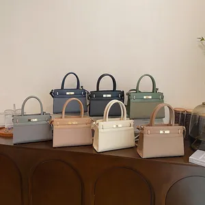 Fashionable women's leather handbags in seven colors with top handles and gold hardware