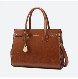 Detailed macro view of dark brown PU leather texture and gold FASHION & BAGS lettering
