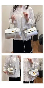 Detailed comparison of two sizes of silver metallic flap bags with gold twist locks