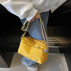 Close-up of yellow jacquard canvas bag with SJCHAO wide strap and front zipper pockets