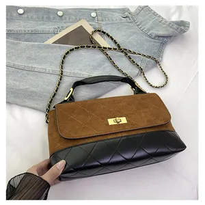Detail showing contrast stitching, matte quilting, and gold twist lock on the crossbody bag