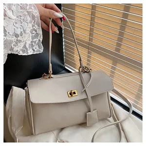 Detail of beige PU leather tote featuring elegant gold twist lock and smooth texture