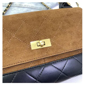 Detailed close-up of quilted suede shoulder bag with gold chain strap and twist lock