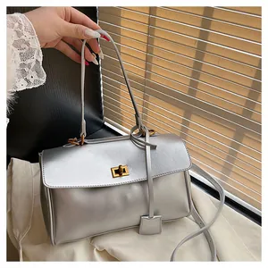 Detail of silver metallic tote bag with golden twist lock and sleek leather texture