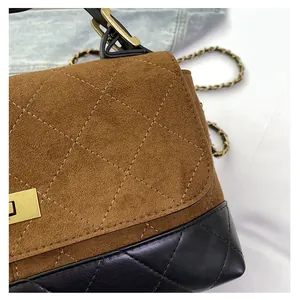 Detail of quilted leather patchwork and golden metal twist lock on the luxury handbag