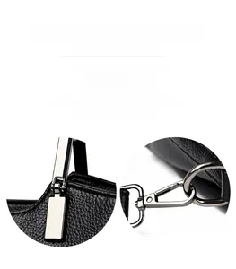 Detail of polished silver hardware and pebbled leather texture on black handbag