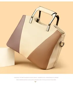 Detail of tricolor leather handbag showing premium lychee texture and silver metal handle