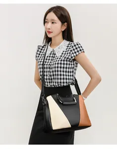 Detail of tricolor leather texture and stitching on the large capacity tote handbag