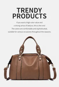 Close-up of brown litchi pattern leather Boston bag with metallic rivet details
