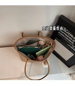 Interior view showing the spacious compartments and inner pockets of this khaki tote bag