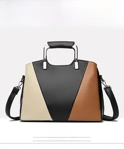 Front view of black color-block tote bag with pebble leather texture and metal handle