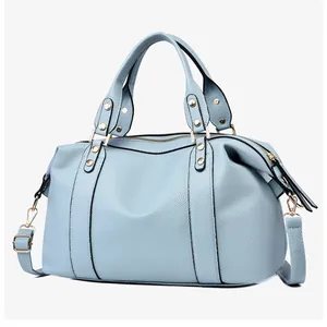Close-up of light blue lychee pattern leather Boston bag with gold hardware detail