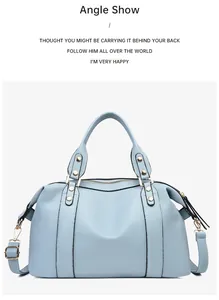 Detail view of light blue Boston bag showing lychee pattern leather and gold metal rivets