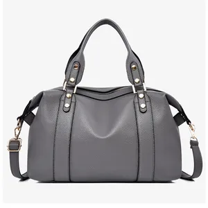 Detail of grey lychee texture Boston bag with golden studs and detachable strap