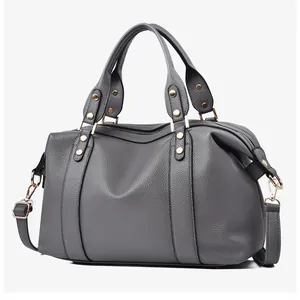 Detailed macro of dark grey lychee pattern leather with elegant gold metal hardware