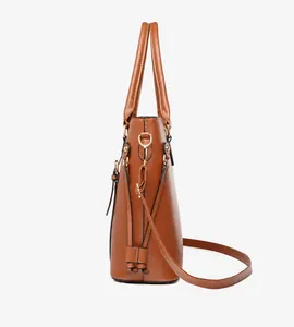 Side view of brown faux leather tote bag showing trapezoid shape and metal d-ring