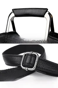 Detail of comfortable leather handle and adjustable silver buckle on black crossbody bag