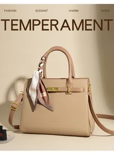 Detail of beige pebbled leather handbag featuring a metal turn-lock and silk scarf handle