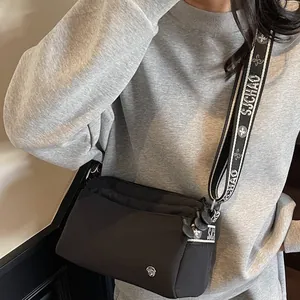 Large capacity black nylon crossbody bag with jacquard strap and multi-layer zippers