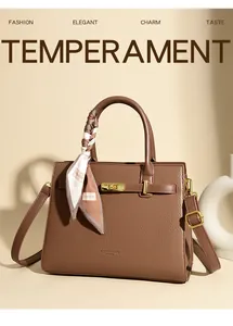Detail of dark brown leather handbag featuring golden lock and decorative silk scarf wrap