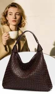 Detail of dark brown leather woven hobo bag showing intricate checkerboard texture
