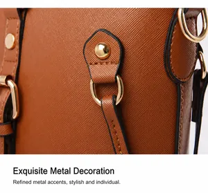 Close-up of caramel leather texture with gold D-ring and rivet on shoulder bag