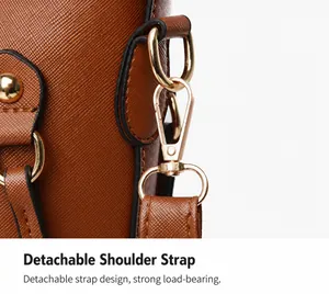 Close-up of brown Saffiano leather bag with detachable gold-tone metal hook and stitching